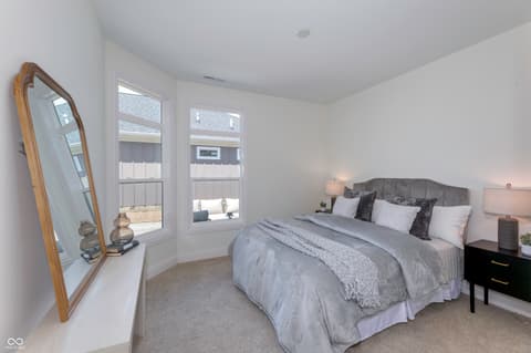 Primary bedroom at 16743 Sunland Farm Drive, Fishers, IN — Bright primary bedroom with expansive bay windows.