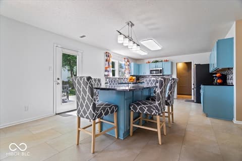Kitchen at 12667 Courage Crossing, Fishers, IN — Bright updated kitchen with blue island and modern finishes.