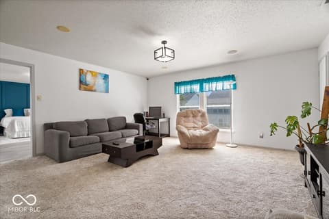 Living room at 12667 Courage Crossing, Fishers, IN — Bright, spacious living room with ample natural light.