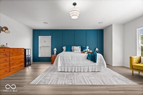 Primary bedroom at 12667 Courage Crossing, Fishers, IN — Spacious primary bedroom with bold teal accent wall.