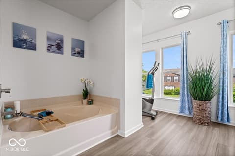 Primary bathroom at 12667 Courage Crossing, Fishers, IN — Spa-like primary bath with soaking tub and natural light.