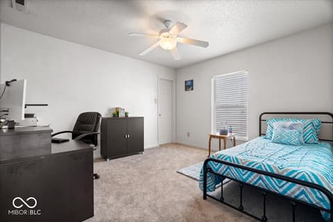 Bedroom at 12667 Courage Crossing, Fishers, IN — Spacious bedroom with dedicated work area and natural light.