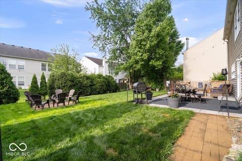 Yard at 12667 Courage Crossing, Fishers, IN — Spacious backyard oasis with mature trees and patio.