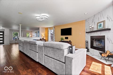 Living room at 12667 Courage Crossing, Fishers, IN — Open living space with fireplace and modern accents.