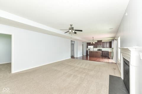 Family room at 11946 Eaglerun Way, Zionsville, IN — Open concept with fireplace and vaulted ceilings.