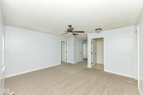 Primary bedroom at 11946 Eaglerun Way, Zionsville, IN — Spacious primary bedroom with walk-in closet access.