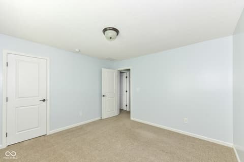 Bedroom at 11946 Eaglerun Way, Zionsville, IN — Spacious bedroom with ensuite access and neutral finishes.