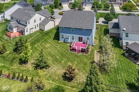 Aerial view at 11946 Eaglerun Way, Zionsville, IN — Spacious property with mature landscaping and deck.