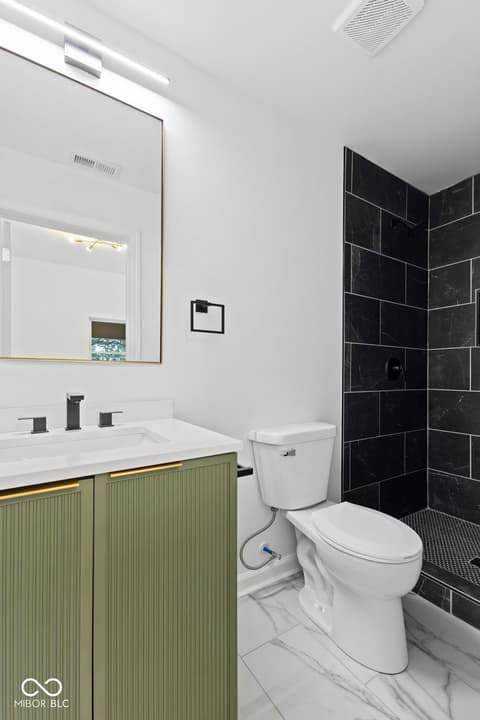 Primary bathroom at 1335 Christian Avenue, Noblesville, IN — Luxe contemporary bath with marble and black tile.