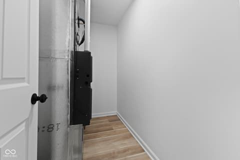 Hallway at 1335 Christian Avenue, Noblesville, IN — Modern hallway with hardwood floors and clean finishes.