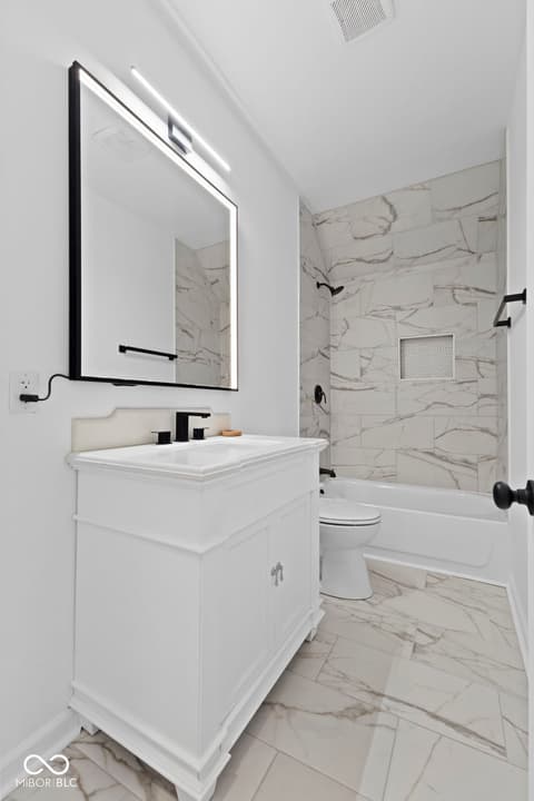 Primary bathroom at 1335 Christian Avenue, Noblesville, IN — Luxurious modern primary bath with marble throughout.