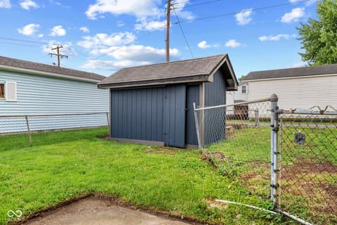 Backyard at 1335 Christian Avenue, Noblesville, IN — Spacious fenced backyard with detached storage shed.