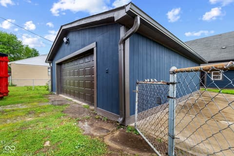 Garage at 1335 Christian Avenue, Noblesville, IN — Standalone garage with metal construction and fencing.