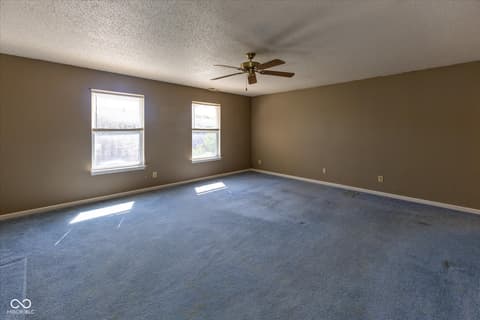 Living room at 10288 Brushfield Lane, Fishers, IN — Spacious living room with abundant natural light.