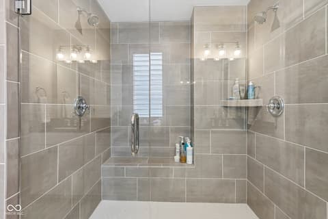 Primary bathroom at 18757 Dooney Court, Noblesville, IN — Luxurious spa-like primary bathroom with dual showerheads.