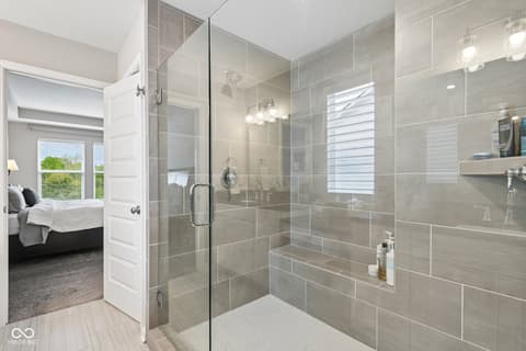 Primary bathroom at 18757 Dooney Court, Noblesville, IN — Luxurious primary bath with oversized walk-in shower.