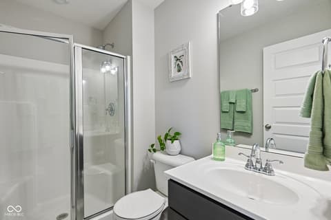 Primary bathroom at 18757 Dooney Court, Noblesville, IN — Fresh modern bathroom with sleek shower and vanity design.