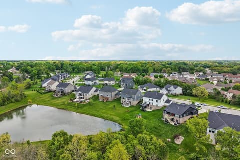 Aerial view at 18757 Dooney Court, Noblesville, IN — Peaceful pond-adjacent community with spacious green lots.