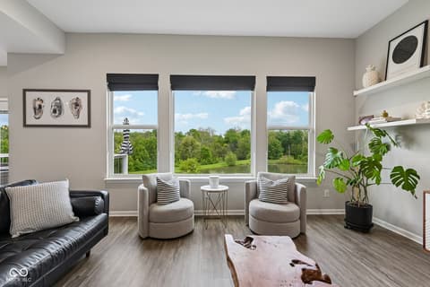 Living room at 18757 Dooney Court, Noblesville, IN — Bright living room with expansive water and landscape views.