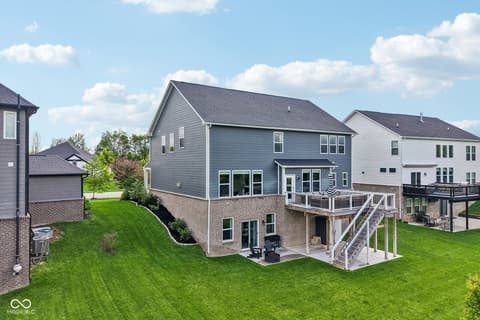 Backyard at 18757 Dooney Court, Noblesville, IN — Modern two-story home with expansive deck and pristine yard.