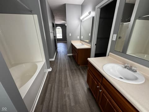 Primary bathroom at 13563 Guy Street, Fishers, IN — Spacious primary bath with dual vanities and soaking tub.