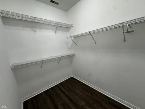 Primary bedroom at 13563 Guy Street, Fishers, IN — Spacious walk-in closet with organized wire shelving.