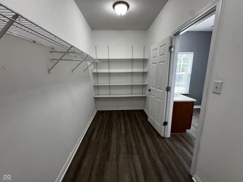 Laundry room at 13563 Guy Street, Fishers, IN — Spacious laundry room with ample shelving and storage.