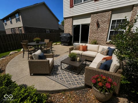 Outdoor living area at 13563 Guy Street, Fishers, IN — Professionally designed backyard oasis with modern patio.