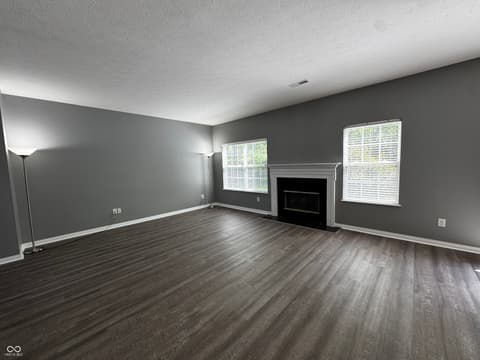 Living room at 13563 Guy Street, Fishers, IN — Spacious living room with fireplace and updated finishes.