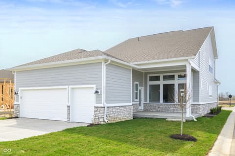Front exterior at 1255 Chatham Hills Boulevard, Westfield, IN — New contemporary home with stone accents and covered porch.