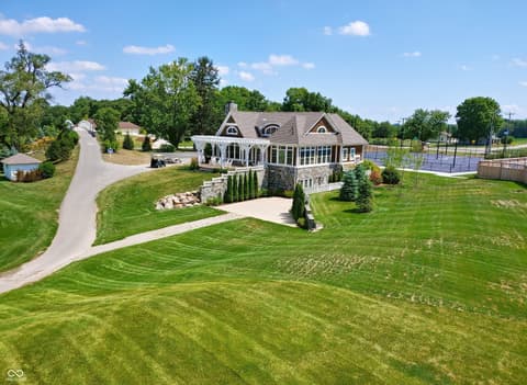 Front exterior at 1255 Chatham Hills Boulevard, Westfield, IN — Stunning estate with circular drive and pristine grounds.